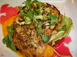 cabbage-wrapped, fennel pollen–dusted striped bass with carrot-ginger & citrus-jalapeño beet purees